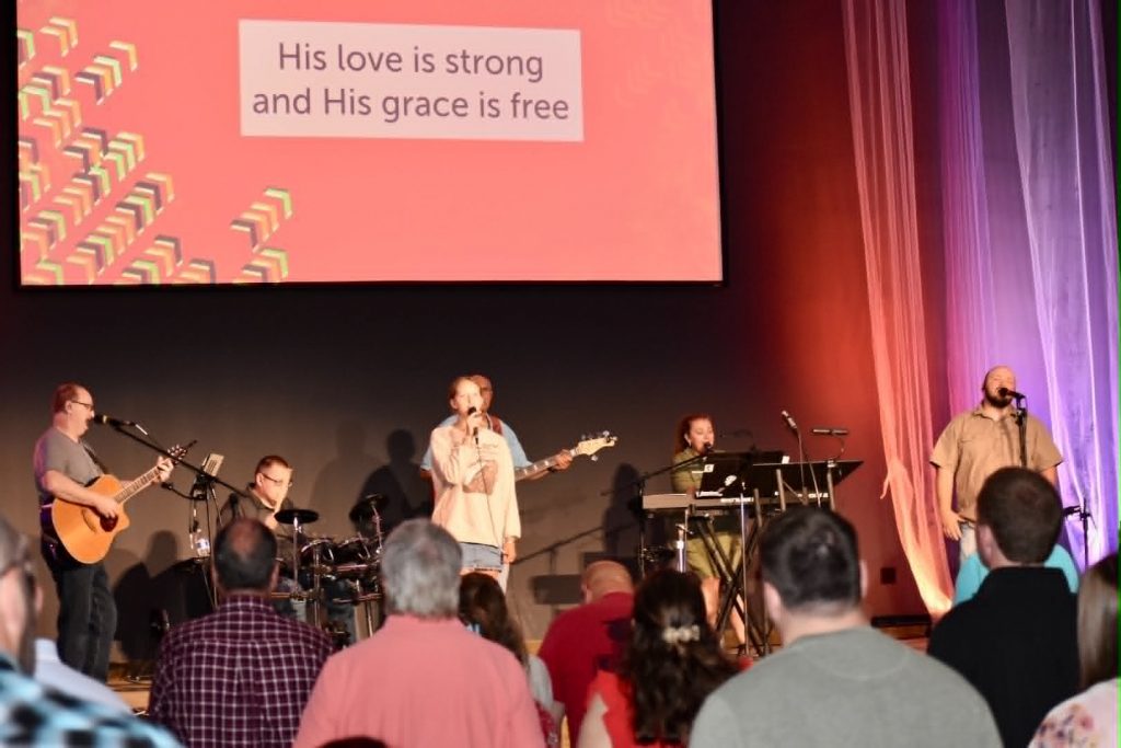 People worshipping on a stage